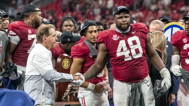 ATLANTA, GA – DECEMBER 4: Phidarian Mathis #48 of the Alabama Crimson Tide shakes hands with Nick Saban during the SEC Championship trophy presentation during a game between Georgia Bulldogs and Alabama Crimson Tide at Mercedes-Benz Stadium on December 4, 2021, in Atlanta, Georgia. (Photo by Steven Limentani/ISI Photos/Getty Images)