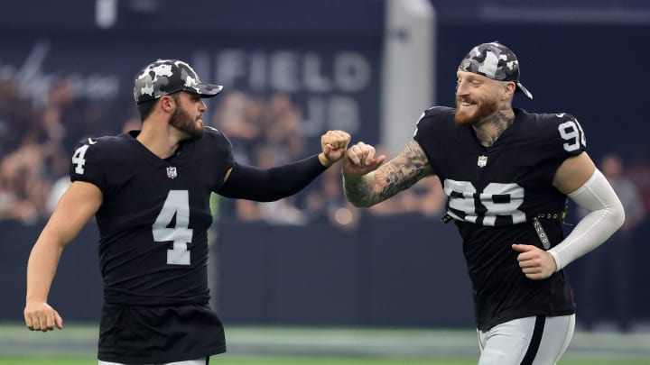 LAS VEGAS, NEVADA – AUGUST 14: Quarterback Derek Carr #4 and defensive end Maxx Crosby #98 of the Las Vegas Raiders bump fists after participating in a coin toss before the team’s preseason game against the Minnesota Vikings at Allegiant Stadium on August 14, 2022, in Las Vegas, Nevada. The Raiders defeated Vikings the 26-20. (Photo by Ethan Miller/Getty Images)