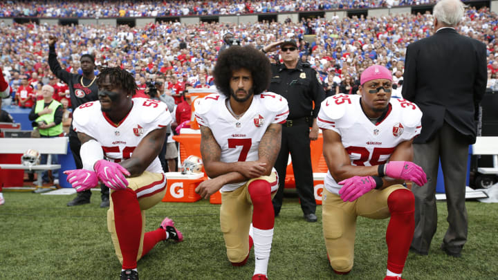 ORCHARD PARK, NY – OCTOBER 15: Eli Harold #58, Colin Kaepernick #7 and Eric Reid #35 of the San Francisco 49ers kneel in protest on the sideline, during the anthem, prior to the game against the Buffalo Bills at New Era Field on October 16, 2016 in Orchard Park, New York. The Bills defeated the 49ers 45-16. (Photo by Michael Zagaris/San Francisco 49ers/Getty Images)