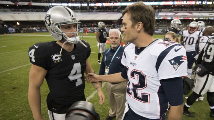 MEXICO CITY, MEXICO - NOVEMBER 19: Tom Brady #12 of the New England Patriots and Derek Carr #4 of the Oakland Raiders shake hands after the game at Estadio Azteca on November 19, 2017 in Mexico City, Mexico. (Photo by Jamie Schwaberow/Getty Images)