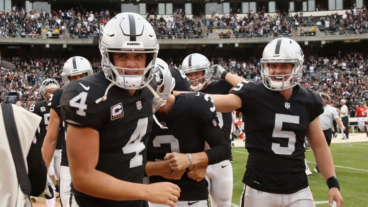 OAKLAND, CA – SEPTEMBER 30: Derek Carr #4 and Johnny Townsend #5 congratulate Matt McCrane #3 of the Oakland Raiders after McCrane kicked the game-winning field goal in overtime against the Cleveland Browns at Oakland-Alameda County Coliseum on September 30, 2018 in Oakland, California. (Photo by Ezra Shaw/Getty Images)