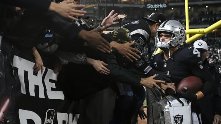 OAKLAND, CA - DECEMBER 24: Derek Carr #4 of the Oakland Raiders greets fans in the stands after their 27-14 win over the Denver Broncos in what may be the final Raiders game at the Oakland-Alameda County Coliseum on December 24, 2018 in Oakland, California. (Photo by Robert Reiners/Getty Images)