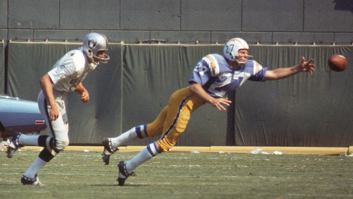 Wide receiver Gary Garrison #27 of the San Diego Chargers reaches for a pass against the coverage of cornerback Kent McCloughan #47 of the Oakland Raiders (Photo by Charles Aqua Viva/Getty Images)