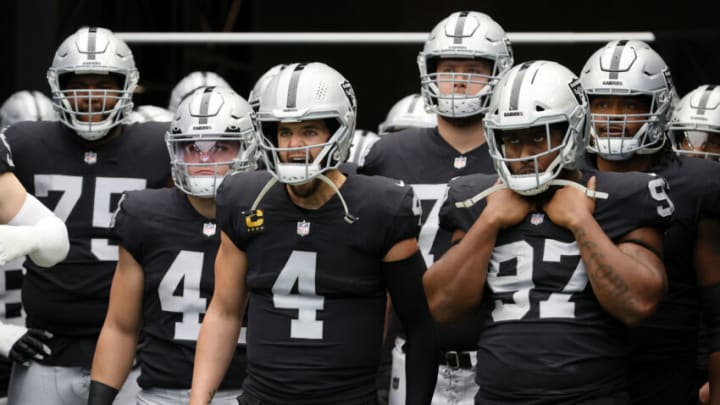 LAS VEGAS, NEVADA - DECEMBER 26: Offensive tackle Brandon Parker #75, running back Sutton Smith #41, quarterback Derek Carr #4 and defensive tackle Damion Square #97 of the Las Vegas Raiders wait to be introduced before a game against the Denver Broncos at Allegiant Stadium on December 26, 2021 in Las Vegas, Nevada. The Raiders defeated the Broncos 17-13. (Photo by Ethan Miller/Getty Images)