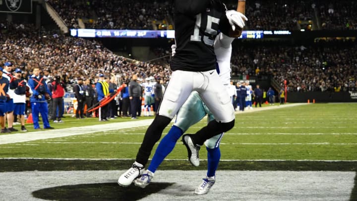 Dec 17, 2017; Oakland, CA, USA; Oakland Raiders wide receiver Michael Crabtree (15) catches the ball ahead of Dallas Cowboys cornerback Chidobe Awuzie (33) for a touchdown during the third quarter at Oakland Coliseum. Mandatory Credit: Kelley L Cox-USA TODAY Sports