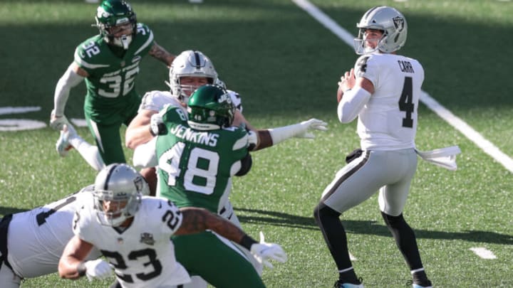 Dec 6, 2020; East Rutherford, New Jersey, USA; Las Vegas Raiders quarterback Derek Carr (4) looks to pass during the first half as New York Jets outside linebacker Jordan Jenkins (48) defends at MetLife Stadium. Mandatory Credit: Vincent Carchietta-USA TODAY Sports