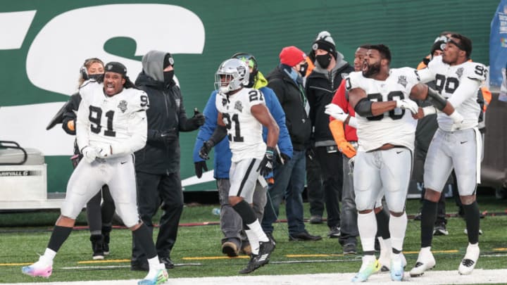 Dec 6, 2020; East Rutherford, New Jersey, USA; Las Vegas Raiders defensive tackle Kendal Vickers (91) and cornerback Amik Robertson (21) and cornerback Nevin Lawson (26) and defensive end Arden Key (99) celebrate a touchdown during the fourth quarter against the New York Jets at MetLife Stadium. Mandatory Credit: Vincent Carchietta-USA TODAY Sports