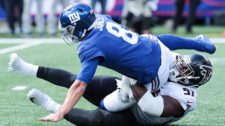 Sep 26, 2021; East Rutherford, New Jersey, USA; New York Giants quarterback Daniel Jones (8) is sacked by Atlanta Falcons defensive tackle Grady Jarrett (97) during the first quarter at MetLife Stadium. Mandatory Credit: Vincent Carchietta-USA TODAY Sports