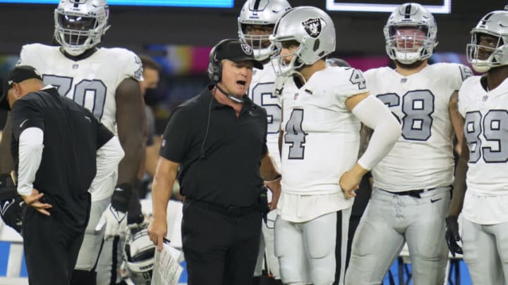 Oct 4, 2021; Inglewood, California, USA; Las Vegas Raiders head coach Jon Gruden talks with quarterback Derek Carr (4) during the second half against the Los Angeles Chargers at SoFi Stadium. Mandatory Credit: Robert Hanashiro-USA TODAY Sports