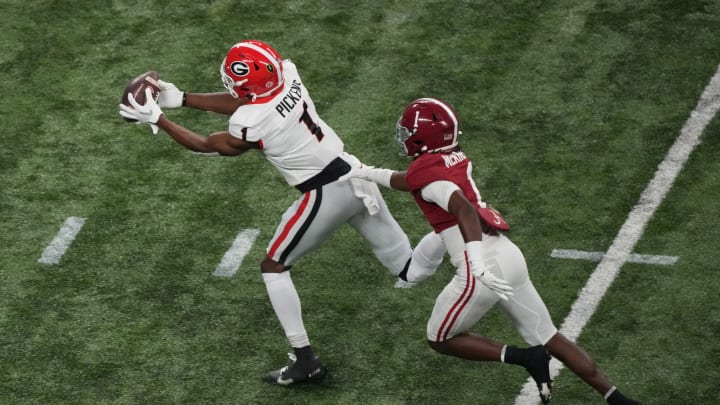Jan 10, 2022; Indianapolis, IN, USA; Georgia Bulldogs wide receiver George Pickens (1) catches a pass against Alabama Crimson Tide defensive back Kool-Aid McKinstry (1) in the first quarter during the 2022 CFP college football national championship game at Lucas Oil Stadium. Mandatory Credit: Joshua Bickel-USA TODAY Sports