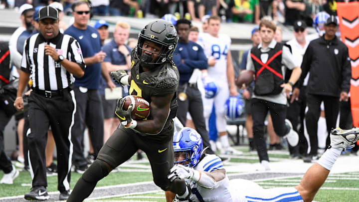 Sep 17, 2022; Eugene, Oregon, USA; Oregon Ducks running back Mar’Keise Irving (0) breaks away from Brigham Young Cougars linebacker Keenan Pili (41) for a first down during the first half at Autzen Stadium. Mandatory Credit: Troy Wayrynen-USA TODAY Sports