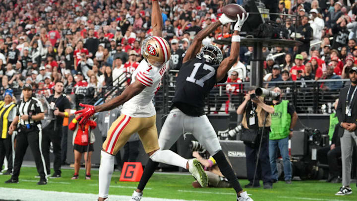 Jan 1, 2023; Paradise, Nevada, USA; Las Vegas Raiders wide receiver Davante Adams (17) makes a touchdown catch behind San Francisco 49ers cornerback Charvarius Ward (7) during the first half at Allegiant Stadium. Mandatory Credit: Stephen R. Sylvanie-USA TODAY Sports