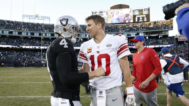 Dec 3, 2017; Oakland, CA, USA; New York Giants quarterback Eli Manning (10) is greeted by Oakland Raiders quarterback Derek Carr (4) after the game at Oakland Coliseum. Mandatory Credit: Cary Edmondson-USA TODAY Sports