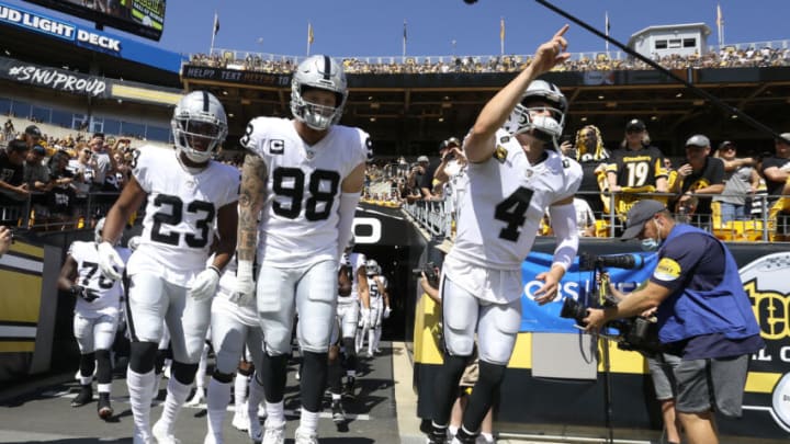 Sep 19, 2021; Pittsburgh, Pennsylvania, USA; Las Vegas Raiders running back Kenyan Drake (23) and defensive end Maxx Crosby (98) and quarterback Derek Carr (4) lead the Raiders onto the field to play the Pittsburgh Steelers at Heinz Field. Mandatory Credit: Charles LeClaire-USA TODAY Sports