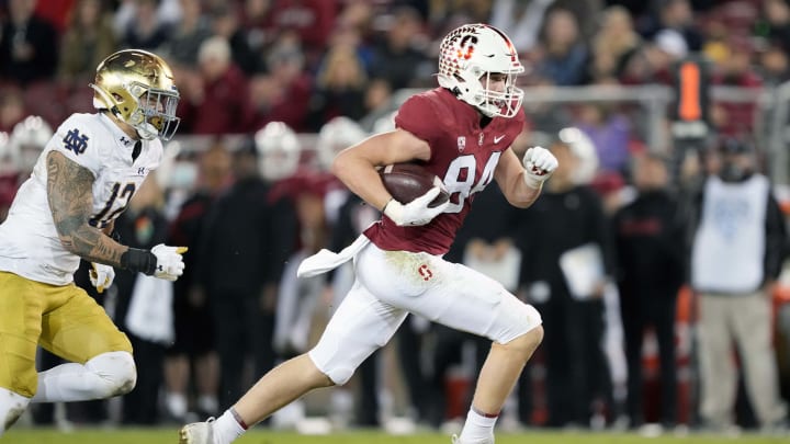 Nov 27, 2021; Stanford, California, USA; Stanford Cardinal tight end Benjamin Yurosek (84) runs after a catch while being pursued by Notre Dame Fighting Irish defensive lineman Jordan Botelho (12) during the fourth quarter at Stanford Stadium. Mandatory Credit: Darren Yamashita-USA TODAY Sports