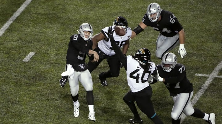 Aug 4, 2022; Canton, Ohio, USA; Las Vegas Raiders quarterback Nick Mullens (9) passes against Jacksonville Jaguars defensive end Jamir Jones (40) in the third quarter during the 2022 Hall of Fame game at Tom Benson Hall of Fame Stadium. Mandatory Credit: Kirby Lee-USA TODAY Sports