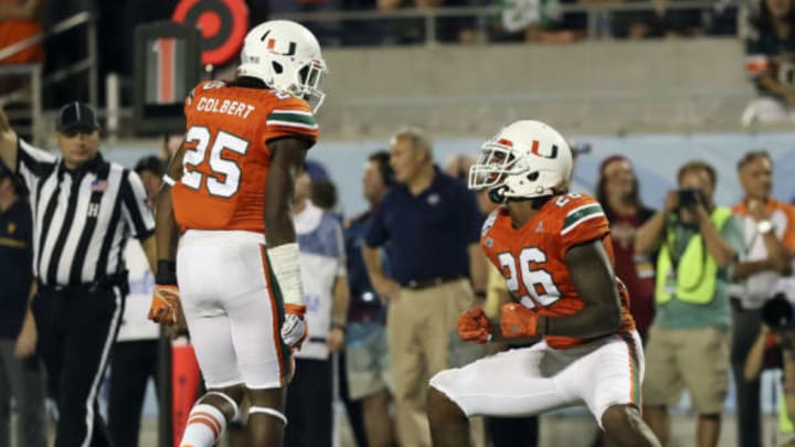 Dec 28, 2016; Orlando, FL, USA; Miami Hurricanes defensive back Rayshawn Jenkins (26) celebrates with defensive back Adrian Colbert (25) after a play in the second half against the West Virginia Mountaineers at Camping World Stadium. The Miami Hurricanes won 31-14. Mandatory Credit: Logan Bowles-USA TODAY Sports