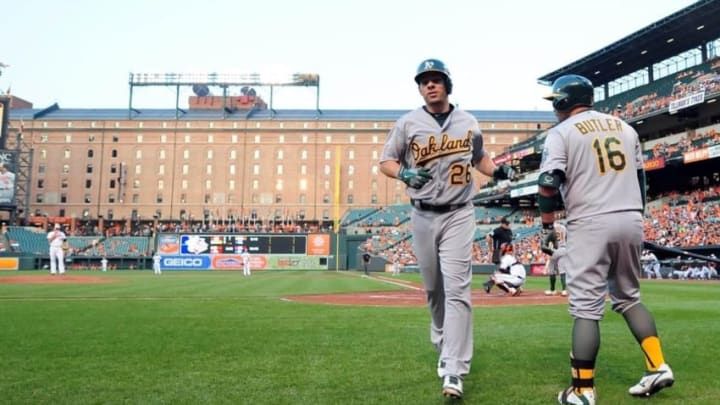 Aug 17, 2015; Baltimore, MD, USA; Oakland Athletics third baseman Danny Valencia (26) high fives designated hitter Billy Butler (16) after hitting a home run in the second inning against the Baltimore Orioles at Oriole Park at Camden Yards. Mandatory Credit: Evan Habeeb-USA TODAY Sports