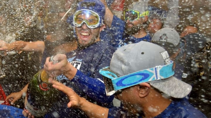 Oct 23, 2015; Kansas City, MO, USA; Kansas City Royals first baseman Eric Hosmer (left) sprays champagne in the clubhouse to celebrate after defeating the Toronto Blue Jays in game six of the ALCS at Kauffman Stadium. Mandatory Credit: Denny Medley-USA TODAY Sports