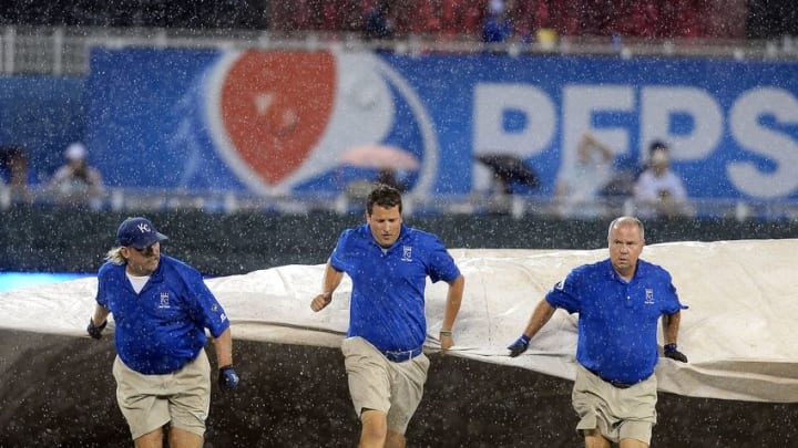 Aug 30, 2016; Kansas City, MO, USA; The grounds crew pulls out the tarp at the start of the sixth inning between the New York Yankees and Kansas City Royals at Kauffman Stadium. Mandatory Credit: John Rieger-USA TODAY Sports