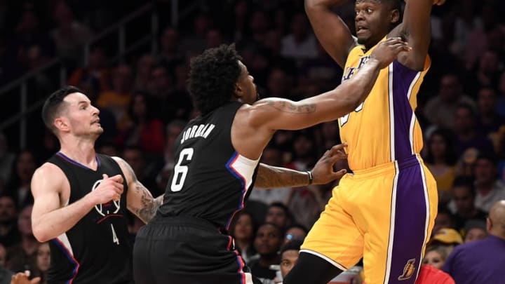 April 6, 2016; Los Angeles, CA, USA; Los Angeles Lakers forward Julius Randle (30) controls the ball against Los Angeles Clippers guard J.J. Redick (4) and center DeAndre Jordan (6) during the second half at Staples Center. Mandatory Credit: Richard Mackson-USA TODAY Sports