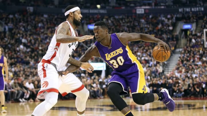 Dec 7, 2015; Toronto, Ontario, CAN; Los Angeles Lakers forward Julius Randle (30) goes to the basket against Toronto Raptors forward James Johnson (3) at Air Canada Centre. The Raptors beat the Lakers 102-93. Mandatory Credit: Tom Szczerbowski-USA TODAY Sports