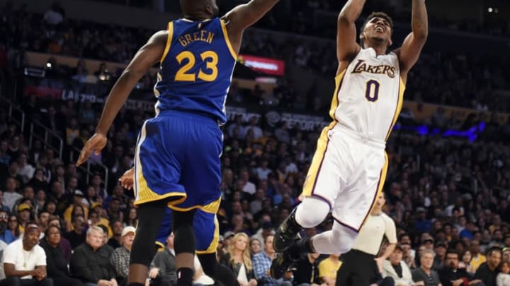 Mar 6, 2016; Los Angeles, CA, USA; Los Angeles Lakers forward Nick Young (0) shoots against Golden State Warriors forward Draymond Green (23) during the NBA game at the Staples Center. Mandatory Credit: Richard Mackson-USA TODAY Sports