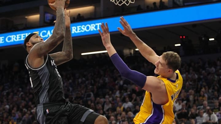 Nov 10, 2016; Sacramento, CA, USA; Sacramento Kings center DeMarcus Cousins (15) shoots the ball against Los Angeles Lakers center Timofey Mozgov (20) during the second half at Golden 1 Center. The Lakers won the game 101-91. Mandatory Credit: Sergio Estrada-USA TODAY Sports
