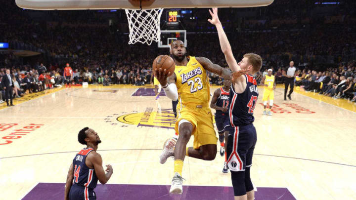 LOS ANGELES, CA - NOVEMBER 29: LeBron James #23 of the Los Angeles Lakers drives to the basket against Davis Bertans #42 and Ish Smith #14 of the Washington Wizards during the first half at Staples Center on November 29, 2019 in Los Angeles, California. NOTE TO USER: User expressly acknowledges and agrees that, by downloading and or using this photograph, User is consenting to the terms and conditions of the Getty Images License Agreement. (Photo by Kevork Djansezian/Getty Images)