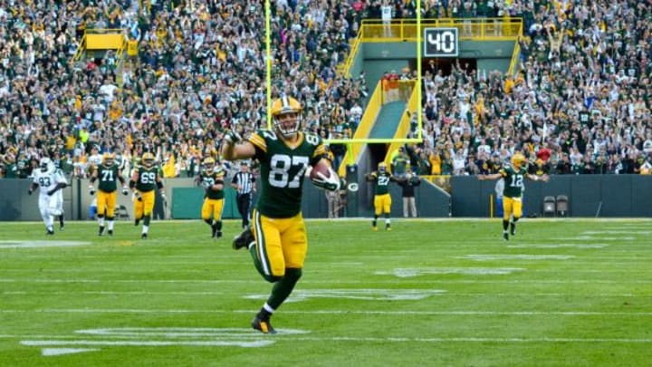 With Aaron Rodgers and his teammates celebrating in the background, Jordy Nelson makes his way toward the end zone on the tail end of his 80-yard touchdown catch and run against the New York Jets last Sunday. Jim Oxley photograph