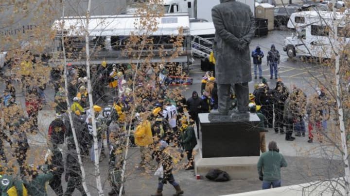 Fans mingle around the statue of Vince Lombardi. Raymond T. Rivard