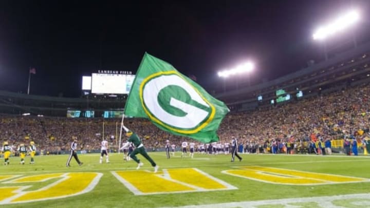 Nov 9, 2014; Green Bay, WI, USA; A Green Bay Packers cheerleader carries a flag during the game against the Chicago Bears at Lambeau Field. Green Bay won 55-14. Mandatory Credit: Jeff Hanisch-USA TODAY Sports
