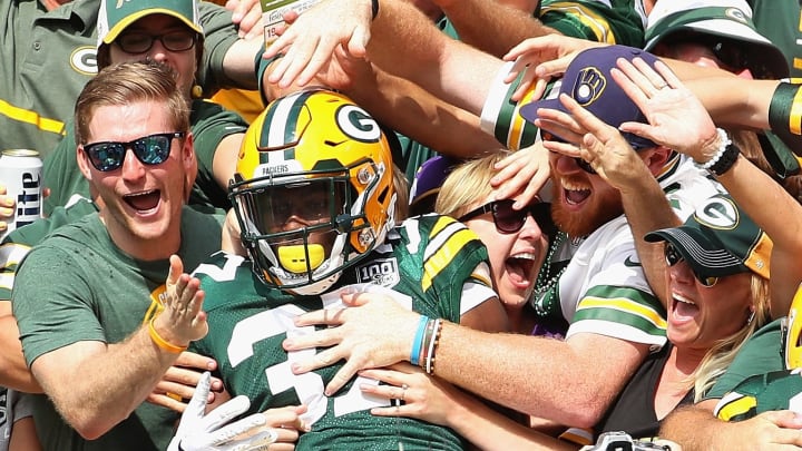 GREEN BAY, WI – SEPTEMBER 16: Josh Jackson #37 of the Green Bay Packers is grabbed by fans as he does a “Lambeau Leap” after blocking a punt and scoring a touchdown against the Minnesota Vikingsat Lambeau Field on September 16, 2018 in Green Bay, Wisconsin. The Vikings and the Packers tied 29-29 after overtime. (Photo by Jonathan Daniel/Getty Images)