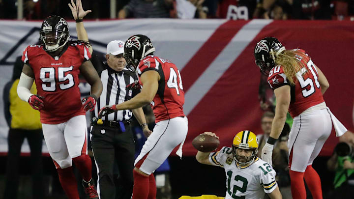 Jan 22, 2017; Atlanta, GA, USA; Green Bay Packers quarterback Aaron Rodgers (12) is tripped up for a loss on the 13-yard line late in the second quarter against the Atlanta Falcons in the 2017 NFC Championship Game at the Georgia Dome. Mandatory Credit: Dan Powers/Appleton Post Crescent via USA TODAY NETWORK