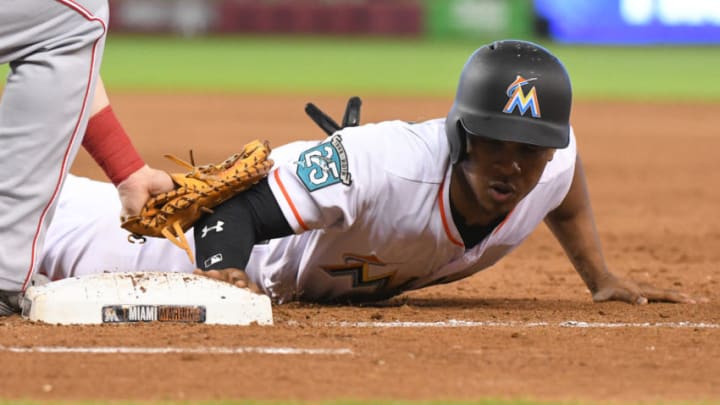 MIAMI, FL - SEPTEMBER 23: Magneuris Sierra #34 of the Miami Marlins dives back into first base on a pickoff attempt during the fourth inning against the Cincinnati Reds at Marlins Park on September 23, 2018 in Miami, Florida. (Photo by Eric Espada/Getty Images)