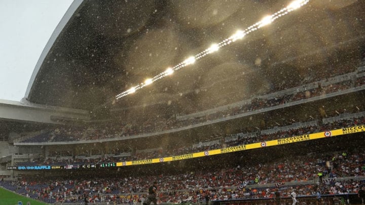 MIAMI, FL - APRIL 06: Teams retreat to the dugout during a rain delay at Marlins Park during Opening Day between the Miami Marlins and the Atlanta Braves on April 6, 2015 in Miami, Florida. (Photo by Mike Ehrmann/Getty Images)