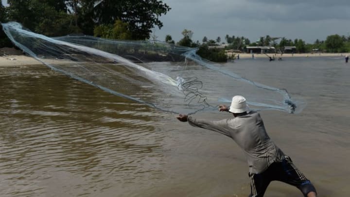 A fishermen casts a net by the sea along shore of Thailand's southern province of Narathiwat on Decmeber 5, 2019. (Photo by Madaree TOHLALA / AFP) (Photo by MADAREE TOHLALA/AFP via Getty Images)