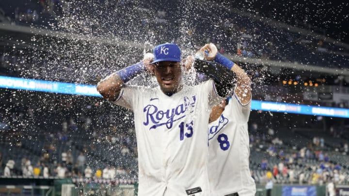 KANSAS CITY, MISSOURI - AUGUST 10: Salvador Perez #13 of the Kansas City Royals is doused with water by Nicky Lopez #8 as they celebrate an 8-4 win over the New York Yankees at Kauffman Stadium on August 10, 2021 in Kansas City, Missouri. (Photo by Ed Zurga/Getty Images)