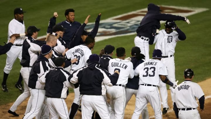DETROIT - OCTOBER 14: Players from the Detroit Tigers celebrate at home plate as Craig Monroe runs home on a 3-run walk-off home run, hit by Magglio Ordonez, against the Oakland Athletics during Game Four of the American League Championship Series October 14, 2006 at Comerica Park in Detroit, Michigan. The Tigers won 6-3 to sweep the Athletics and advance to the World Series. (Photo by Jonathan Daniel/Getty Images)
