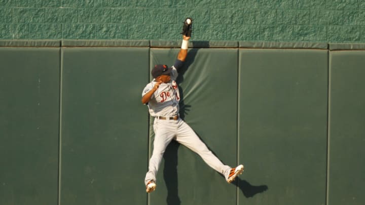 Austin Jackson reaches over the wall to rob the Royals' Alex Gordon of a home run on August 6, 2011 in Kansas City. (Photo by Ed Zurga/Getty Images)