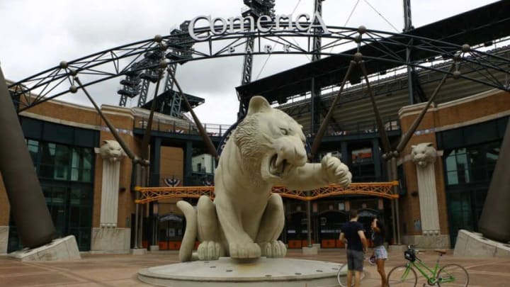 Ed Smith, 33, of Miami, left, and Roberta Souza, 39, of New York talk in front of the big tiger statue during Detroit Tigers' Opening Day at Comerica Park on Monday, July 27, 2020.0e6a3363 big tiger, tiger statue, empty, Comerica Park logo, Comerica Park entrance