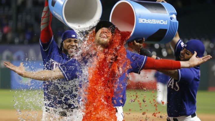 ARLINGTON, TX - APRIL 3: Hunter Pence #24 of the Texas Rangers is given a Powerade bath by teammates Elvis Andrus #1, left, and Rougned Odor #12 at Globe Life Park in Arlington on April 3, 2019 in Arlington, Texas. The Rangers defeated the Houston Astros 4-0. (Photo by Ron Jenkins/Getty Images)