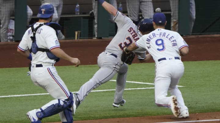 Sep 26, 2020; Arlington, Texas, USA; Houston Astros center fielder Myles Straw (3) is tagged by Texas Rangers third baseman Isiah Kiner-Falefa (9) in a run-down between third base and home as catcher Jeff Mathis (2) watches during the third inning at Globe Life Field. Mandatory Credit: Jim Cowsert-USA TODAY Sports