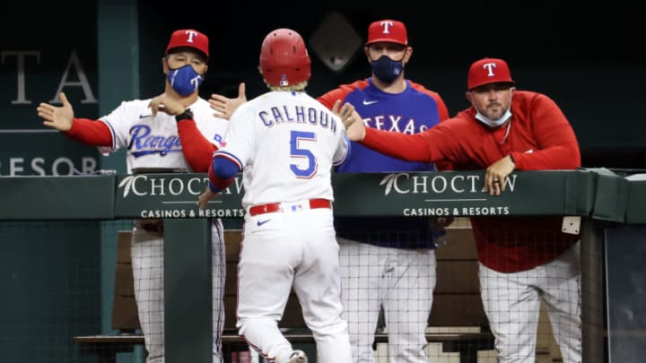 Apr 27, 2021; Arlington, Texas, USA; Texas Rangers designated hitter Willie Calhoun (5) celebrates with teammates after scoring during the fourth inning against the Los Angeles Angels at Globe Life Field. Mandatory Credit: Kevin Jairaj-USA TODAY Sports