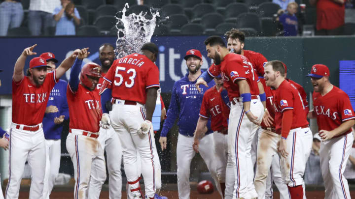 May 21, 2021; Arlington, Texas, USA; Texas Rangers center fielder Adolis Garcia (53) celebrates with teammates at home plate after hitting a walk-off three run home run during the tenth inning to defeat the Houston Astros at Globe Life Field. Mandatory Credit: Kevin Jairaj-USA TODAY Sports