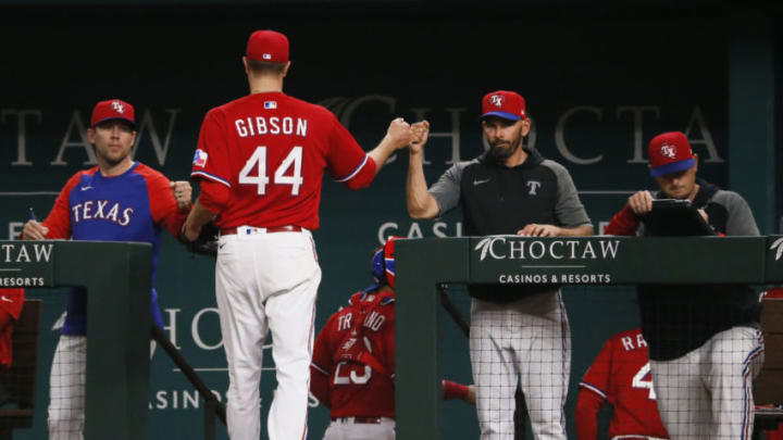 Jun 4, 2021; Arlington, Texas, USA; Texas Rangers starting pitcher Kyle Gibson (44) fist pumps manager Chris Woodward (8) as he heads to the dugout after pitching the top of the fourth inning against the Tampa Bay Rays at Globe Life Field. Mandatory Credit: Raymond Carlin III-USA TODAY Sports