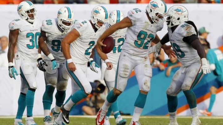 Sep 22, 2013; Miami Gardens, FL, USA; Miami Dolphins long snapper John Denney (92) celebrates with teammates after recovering an Atlanta Falcons fumble in the second half at Sun Life Stadium. Miami won 27-23. Mandatory Credit: Robert Mayer-USA TODAY Sports