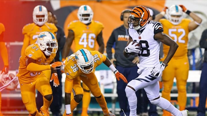 Sep 29, 2016; Cincinnati, OH, USA; Cincinnati Bengals wide receiver A.J. Green (18) carries the ball past Miami Dolphins defensive back Tony Lippett (36) and free safety Michael Thomas (31) in the first half at Paul Brown Stadium. Mandatory Credit: Aaron Doster-USA TODAY Sports
