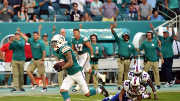 Oct 23, 2016; Miami Gardens, FL, USA; Miami Dolphins wide receiver Kenny Stills (10) runs past Buffalo Bills defensive back Jonathan Meeks (36) and Buffalo Bills cornerback Ronald Darby (28) for a touchdown during the second half at Hard Rock Stadium. The Dolphins won 28-25. Mandatory Credit: Steve Mitchell-USA TODAY Sports