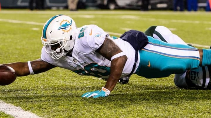 Dec 17, 2016; East Rutherford, NJ, USA; Miami Dolphins tight end Dion Sims (80) reaches for the goal line against the New York Jets in the third quarter at MetLife Stadium. Mandatory Credit: Dennis Schneidler-USA TODAY Sports